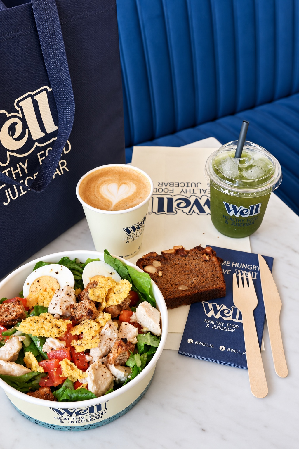A Well lunch with a fresh salad, banana bread, coffee and a green drink
